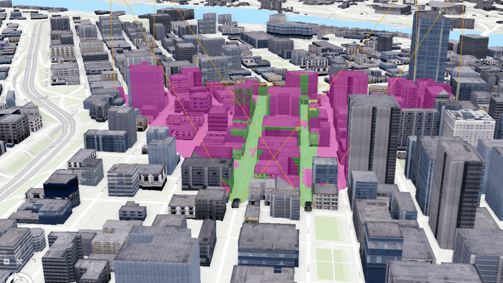 Ein 3D-Modell eines Stadtzentrums. Mehrere Gebäude sind in Rosa- und Grüntönen hervorgehoben, um Zonen oder Interessensbereiche innerhalb der Stadt zu kennzeichnen.