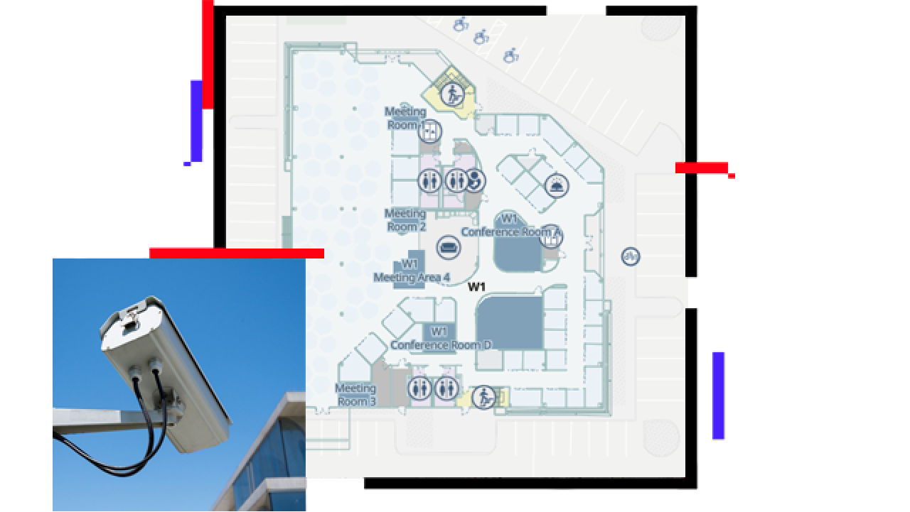 A security camera on mounted on a building and floor plan map in the background showing the building's interior